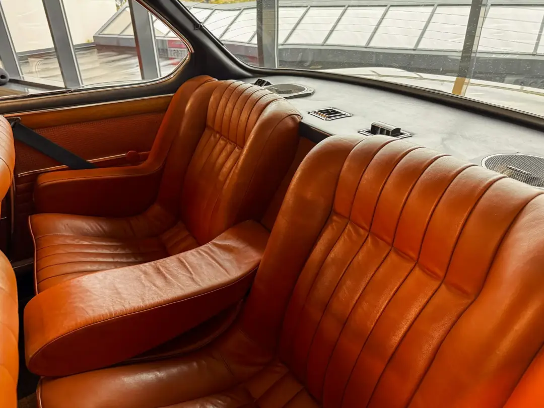 Orange leather seats in a vintage car